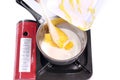 Add butter to the milk in the saucepan membuat kue muffin Royalty Free Stock Photo